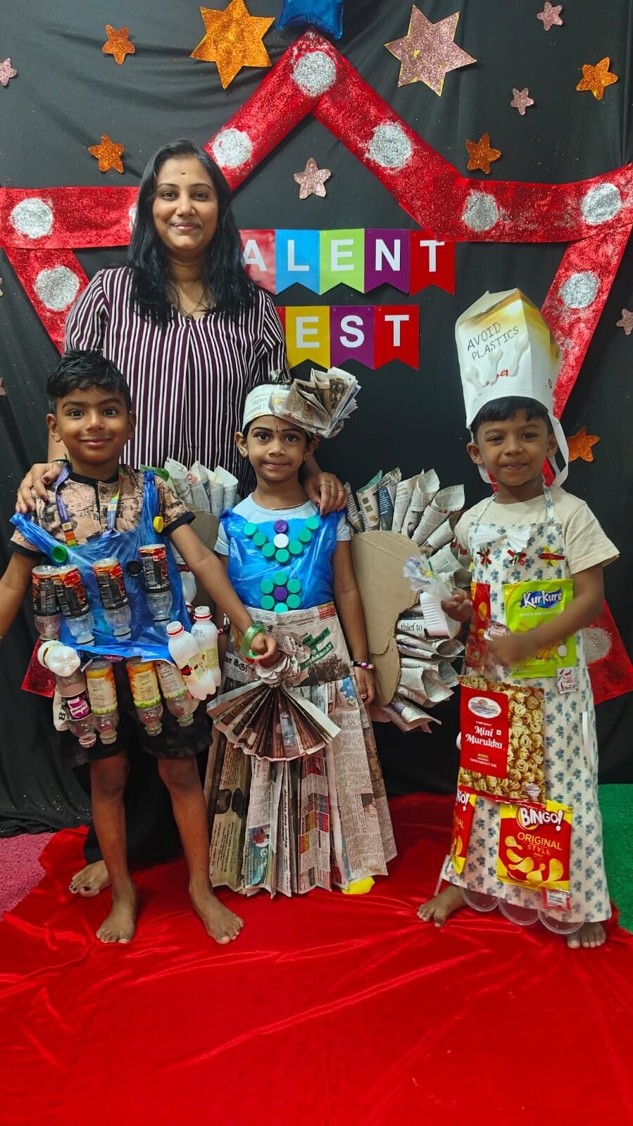 Children in creative recycled-material costumes for Talent Fest